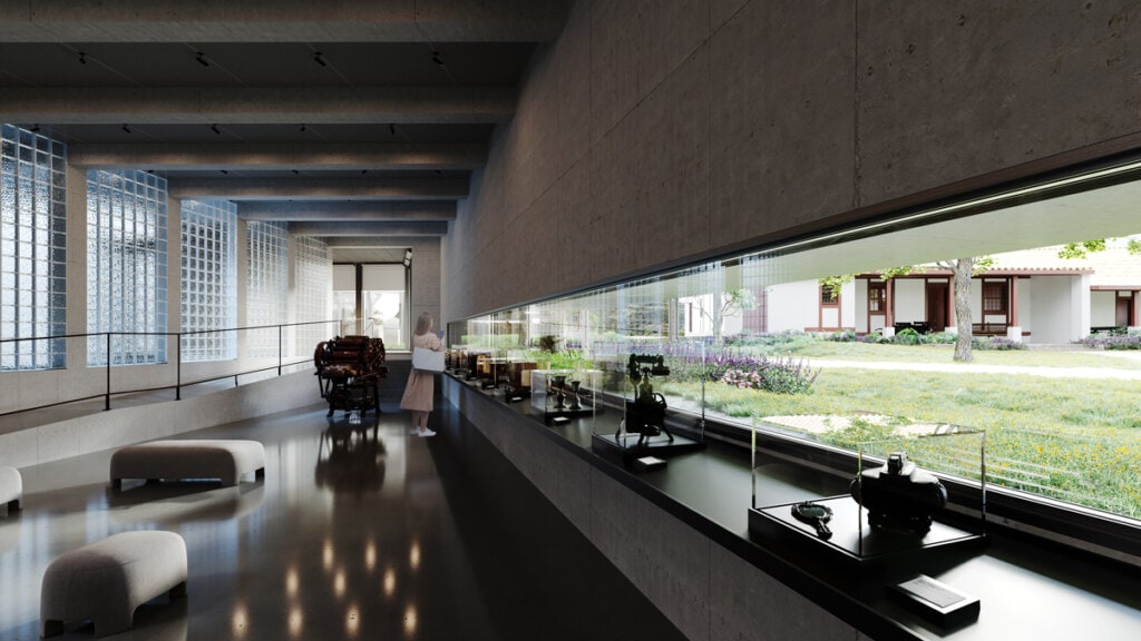 The marquee associated with the horizontal fenestration of the exhibition room ensures that the sun does not fall directly on the exhibits without obstructing the framed view. The monolithic tectonics of the façade make this one-off effort possible, as it horizontally compliments the garden lawn close to the eye.